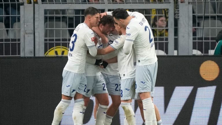 Hoffenheim's Jacob Bruun Larsen, second left, celebrates with teammates after scoring his side's first goal during the German Bundesliga soccer match between Borussia Dortmund and TSG Hoffenheim at the Signal-Iduna Park in Dortmund, Germany, Sunday, Dec. 15 2024. (Martin Meissner/AP)