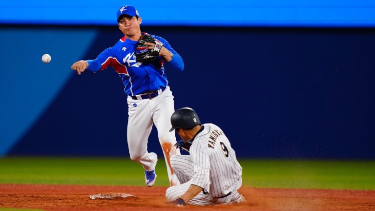 FILE - South Korea's Hyeseong Kim throws to first after forcing out Japan's Yuki Yanagita during a semi-final baseball game at the 2020 Summer Olympics, Wednesday, Aug. 4, 2021, in Yokohama, Japan. (AP/Matt Slocum, File)