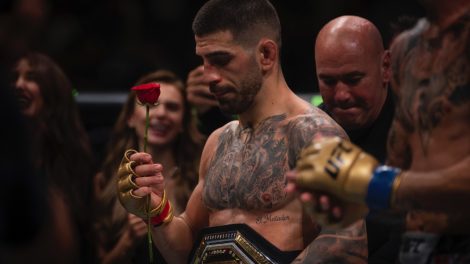 UFC-featherweight-champion-Ilia-Topuria,-holds-a-rose-presented-to-him-by-his-wife-after-winning-a-featherweight-title-mixed-martial-arts-bout-against-Max-Holloway-at-UFC-308-in-Abu-Dhabi