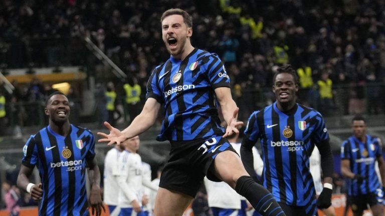 Inter Milan's Carlos Augusto, center, celebrates after scoring against Como during a Serie A soccer match between Inter Milan and Como at the San Siro stadium in Milan, Italy, Monday, Dec. 23, 2024. (Luca Bruno/AP)