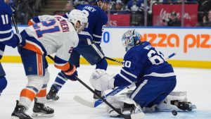 New York Islanders centre Kyle Palmieri (21) looks on as teammate Isaiah George, not shown, scores on Toronto Maple Leafs goaltender Joseph Woll (60) during third period NHL action in Toronto on Saturday, Dec. 21, 2024. (Frank Gunn/CP)