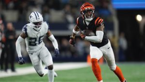 Cincinnati Bengals wide receiver Ja'Marr Chase runs for a touchdown past Dallas Cowboys cornerback DaRon Bland during the second half of a football game, Monday, Dec. 9, 2024, in Arlington, Texas. The Cincinnati Bengals won 27-20. (AP/Julio Cortez)