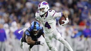 Buffalo Bills running back James Cook (4) runs against Detroit Lions defensive end Za'Darius Smith during the first half of an NFL football game, Sunday, Dec. 15, 2024, in Detroit. (Rey Del Rio/AP)