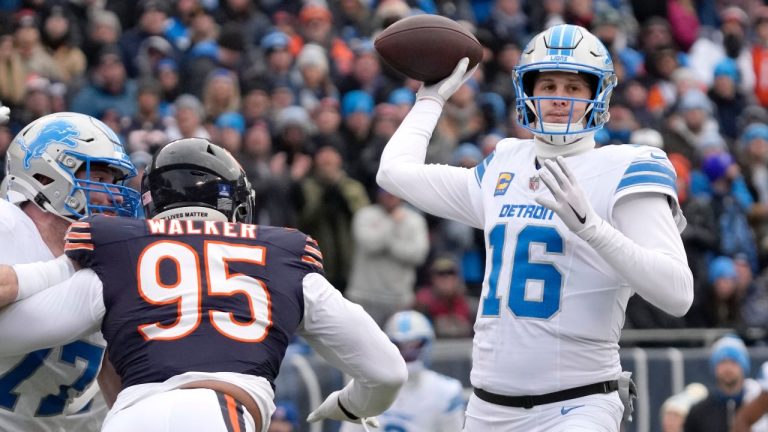 Detroit Lions quarterback Jared Goff passes under pressure from Chicago Bears defensive end DeMarcus Walker during the first half of an NFL game Sunday, Dec. 22, 2024, in Chicago. (AP/Nam Y. Huh)