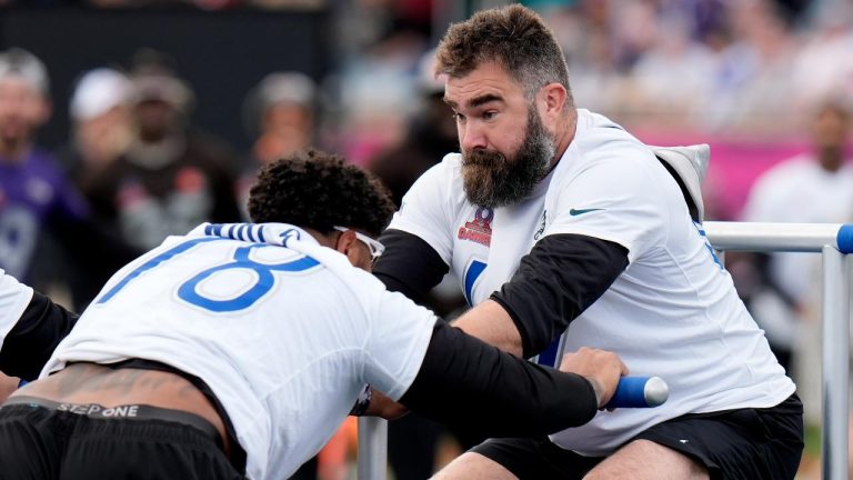 Former NFC center Jason Kelce, right, is pushed on the sled by NFC tackle Tristan Wirfs, of the Tampa Bay Buccaneers, during the skills competition event at the NFL Pro Bowl football game. (Chris O'Meara/AP)