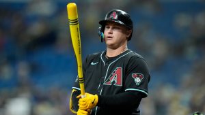 Arizona Diamondbacks' Joc Pederson holds his bat painted like a crayon during the first inning of a baseball game against the Tampa Bay Rays on Players' Weekend Friday, Aug. 16, 2024, in St. Petersburg, Fla. (Chris O'Meara/AP)