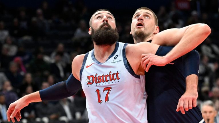 Washington Wizards centre Jonas Valanciunas and Denver Nuggets centre Nikola Jokic, right, compete for a rebound during the first half of an NBA basketball game Saturday, Dec. 7, 2024, in Washington. (John McDonnell/AP)