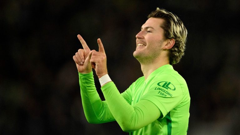 Wolfsburg's Jonas Wind celebrates scoring his side's second goal during a German Cup soccer match between Wolfsburg and Hoffenheim, at the Volkswagen Arena in Wolfsburg, Germany, Wednesday, Dec. 4, 2024. (Swen Pförtner/dpa/AP)