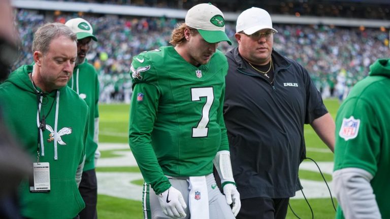 Philadelphia Eagles quarterback Kenny Pickett (7) walks with Dom DiSandro, right, senior advisor to the general manager, chief security officer and gameday coaching operations, along with trainers on his way to the locker room after going down on a play against the Dallas Cowboys. (Chris Szagola/AP)