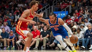 New York Knicks guard Jalen Brunson (11) drives the base line while guarded by Atlanta Hawks guard Dyson Daniels, left, during the second half of an NBA basketball game, Wednesday, Nov. 6, 2024, in Atlanta. (AP Photo/Jason Allen)