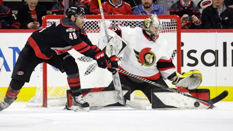 Ottawa Senators goaltender Leevi Merilainen defends against Carolina Hurricanes left wing Jordan Martinook during the third period of an NHL game, Tuesday, April 4, 2023, in Raleigh, N.C. (AP/Chris Seward)