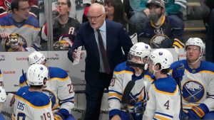 Buffalo Sabres head coach Lindy Ruff, center top, talks to his players during the third period of an NHL hockey game against the San Jose Sharks in San Jose, Calif., Saturday, Nov. 23, 2024. (Tony Avelar/AP)