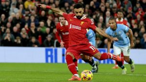 Liverpool's Mohamed Salah scores his side's second goal from the penalty spot during the English Premier League soccer match between Liverpool and Manchester City at Anfield Stadium, Liverpool, England, Sunday Dec. 1, 2024. (AP Photo/Ian Hodgson)