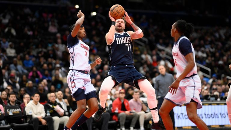 Dallas Mavericks guard Luka Doncic (77) goes to the basket as he was fouled by Washington Wizards guard Bilal Coulibaly (0) during the second half of an NBA basketball game, Thursday, Dec. 5, 2024, in Washington. The Mavericks won 137-101. (Nick Wass/AP)