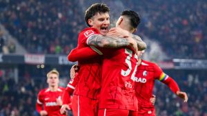 Freiburg's Lukas Kübler, left, celebrates scoring with teammate Vincenzo Grifo during the Bundesliga soccer match between SC Freiburg and VfL Wolfsburg. (Tom Weller/dpa via AP)