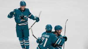 San Jose Sharks centre Macklin Celebrini (71) celebrates with William Eklund, right, and Will Smith after scoring a goal during the third period of an NHL game against the Los Angeles Kings, Monday, Nov. 25, 2024, in San Jose, Calif. (AP/Godofredo A. Vásquez)