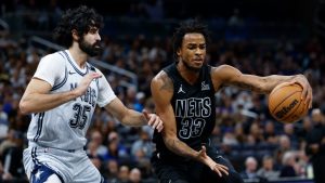 Orlando Magic center Goga Bitadze (35) defends against Brooklyn Nets center Nic Claxton (33) during the first half of an NBA basketball game, Sunday, Dec. 29, 2024, in Orlando, Fla. (AP Photo/Kevin Kolczynski)