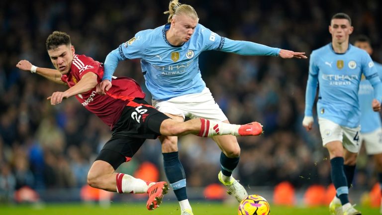 Manchester City's Erling Haaland, centre, challenges for the ball with Manchester United's Manuel Ugarte during the English Premier League soccer match between Manchester City and Manchester United at the Etihad Stadium in Manchester, Sunday, Dec. 15, 2024. (Dave Thompson/AP)