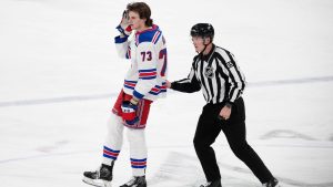 New York Rangers centre Matt Rempe is escorted to the penalty box by official Tommy Hughes, before being ejected for game misconduct, in the third period of an NHL game against the Dallas Stars in Dallas, Friday, Dec. 20, 2024. (AP/Tony Gutierrez)