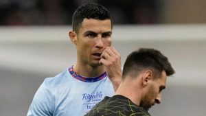 Cristiano Ronaldo gestures playing for a combined XI of Saudi Arabian teams Al Nassr and Al Hilal is flanked by PSG's Lionel Messi during a friendly soccer match, at the King Saud University Stadium, in Riyadh, Saudi Arabia, Thursday, Jan. 19, 2023. (Hussein Malla/AP)