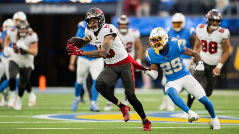 Tampa Bay Buccaneers wide receiver Mike Evans (13) runs with the ball past Los Angeles Chargers cornerback Tarheeb Still (29) during an NFL football game, Sunday, Dec. 15, 2024, in Inglewood, Calif. (Kyusung Gong/AP)