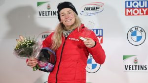 Second placed Mirela Rahneva from Canada on the podium during the award ceremony following the second run of the women's skeleton World Cup race in Winterberg, Germany, Friday, Jan. 6, 2023. (Friso Gentsch/dpa via AP)