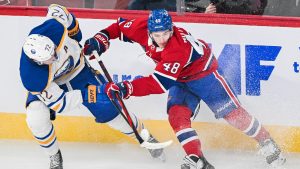 Montreal Canadiens' Lane Hutson (48) and Buffalo Sabres' Tage Thompson (72) vie for the puck during first period NHL hockey action in Montreal, Tuesday, December 17, 2024. (Graham/CP)