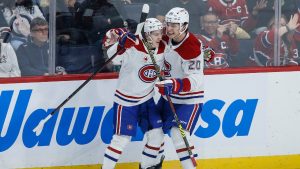 Montreal Canadiens' Lane Hutson (48) and Juraj Slafkovsky (20) celebrate Hutson’s goal against the Winnipeg Jets during first period NHL action in Winnipeg, Saturday, Dec. 14, 2024. (John Woods/CP)