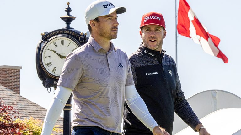 Canadians Nick Taylor (left) and Taylor Pendrith walk down the fairway after their tee shots on the 1st hole in the first round of the Canadian Open on May 30th, 2024. (Frank Gunn/CP)