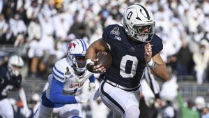 Penn State linebacker Dominic DeLuca returns an interception for a touchdown while being chased by SMU running back Brashard Smith during the first half in the first round of the NCAA College Football Playoff, Saturday, Dec. 21, 2024, in State College, Pa. (Barry Reeger/AP)
