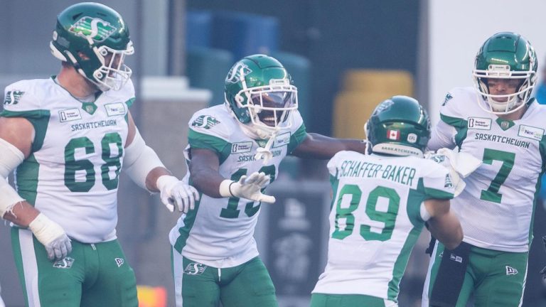 Saskatchewan Roughriders' Samuel Emilus (second left) celebrates a touchdown with Noah Zerr (68), Kian Schaffer-Baker (89) and quarterback Trevor Harris (7) against the Edmonton Elks during first half CFL action. (Jason Franson/CP)