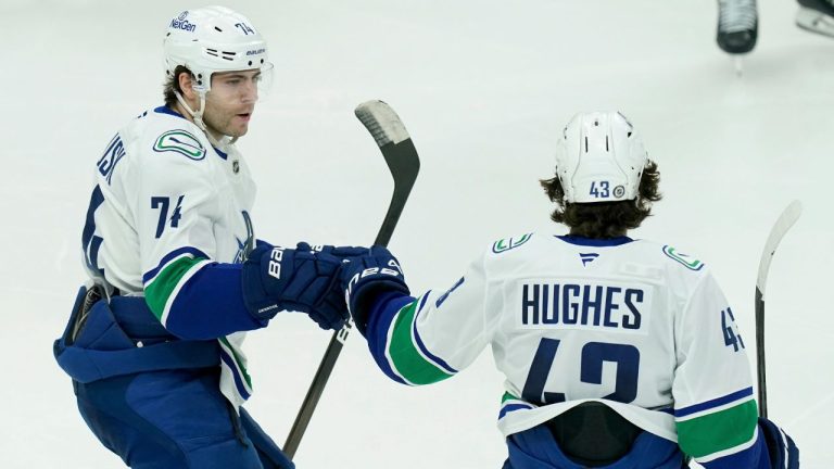 Vancouver Canucks' Quinn Hughes celebrates with Jake DeBrusk. (Matt Freed/AP)