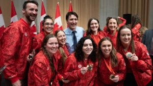 Prime Minister Justin Trudeau poses for a photo with Olympians and Paralympians during an event in the Parliamentary precinct, in Ottawa, Wednesday, Dec. 4, 2024. (Adrian Wyld/CP)