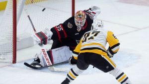 Ottawa Senators goaltender Linus Ullmark (35) deflects a shot from Pittsburgh Penguins centre Sidney Crosby over the net during second period NHL action in Ottawa, Saturday, Dec. 14, 2024. (Adrian Wyld/CP)