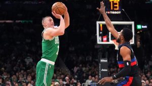 Boston Celtics guard Payton Pritchard, left, shoots a 3-pointer over Detroit Pistons guard Malik Beasley, right, during the first half of an NBA basketball game, Thursday, Dec. 12, 2024, in Boston. (Charles Krupa/AP)