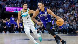 Sacramento Kings forward Keegan Murray (13) drives to the basket past Indiana Pacers guard Tyrese Haliburton (0) during the first half of an NBA basketball game Sunday, Dec. 22, 2024, in Sacramento, Calif. (Sara Nevis/AP)