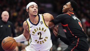 Indiana Pacers' Andrew Nembhard (2) drives past Toronto Raptors' RJ Barrett (9) during first half NBA basketball action in Toronto on Tuesday, December 3, 2024. THE CANADIAN PRESS/Frank Gunn