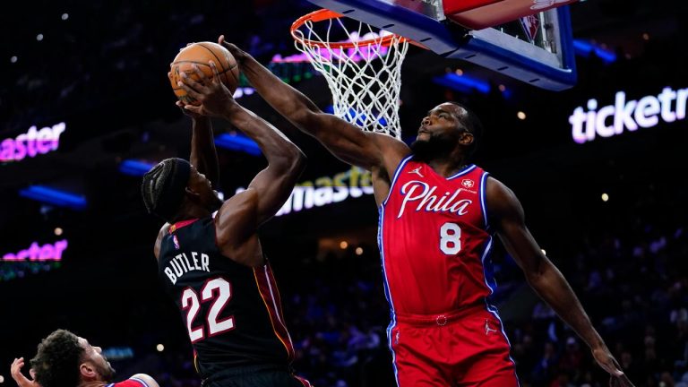 Miami Heat's Jimmy Butler (22) goes up for a shot against Philadelphia 76ers' Paul Millsap (8) during the first half of an NBA basketball game, Monday, March 21, 2022. (Matt Slocum/AP)