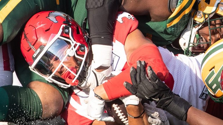 Calgary Stampeders Jalen Philpot (85) gets tackled by Edmonton Elks Daniel Joseph (49) along with Calgary's Eric Smith (68) during CFL action in Edmonton, Alberta, on Saturday September 7, 2024. (Amber Bracken/CP)