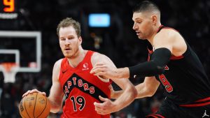 Toronto Raptors' Jakob Poeltl (19) drives past Chicago Bulls' Nikola Vucevic (9) during second half NBA basketball action in Toronto on Monday, December 16, 2024. THE CANADIAN PRESS/Frank Gunn