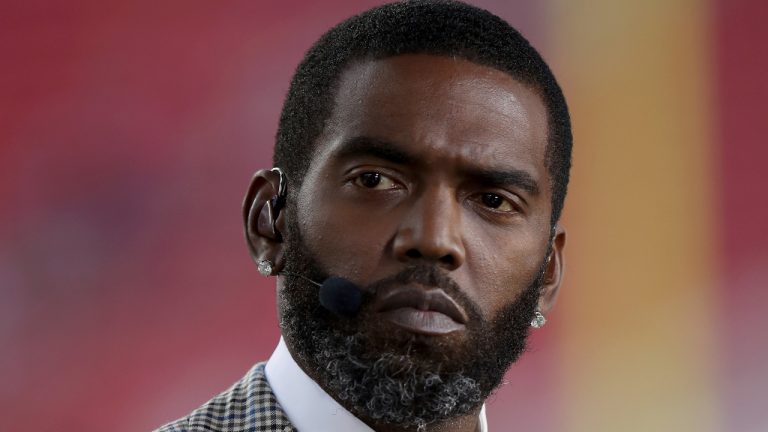 Broadcaster Randy Moss sits on the sideline before an NFL football game between the San Francisco 49ers and the Los Angeles Rams. (Scot Tucker/AP)