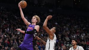 Toronto Raptors guard Gradey Dick (1) scores past Brooklyn Nets centre Nic Claxton (33) during first half NBA basketball action in Toronto on Thursday, December 19, 2024. (Nathan Denette/CP)