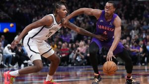 Toronto Raptors forward Scottie Barnes (4) tries to drive past Brooklyn Nets forward Noah Clowney (21) during first half NBA basketball action in Toronto on Thursday, December 19, 2024. (Nathan Denette/CP)