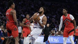 New York Knicks center Karl-Anthony Towns, center, drives to the basket between Toronto Raptors forward Scottie Barnes (4) and RJ Barrett (9) during the second half of an NBA basketball game Monday, Dec. 23, 2024, in New York. (Adam Hunger/AP)