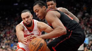 Houston Rockets forward Dillon Brooks (9) and Toronto Raptors forward Scottie Barnes (4) vie for control of the ball during second half NBA basketball action in Toronto, Sunday, Dec. 22, 2024. (Frank Gunn/CP)