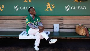 Former baseball player Rickey Henderson laughs as he sits in the dugout before a baseball game between the Oakland Athletics and the Texas Rangers, Thursday, Sept. 26, 2024, in Oakland, Calif. (Godofredo A. Vásquez/AP)