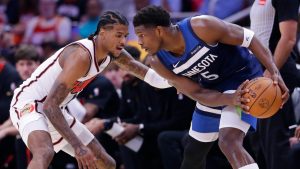 Minnesota Timberwolves guard Anthony Edwards (5) looks to drive around Houston Rockets guard Jalen Green, left, during the first half of an NBA basketball game Friday, Dec. 27, 2024, in Houston. (AP Photo/Michael Wyke)