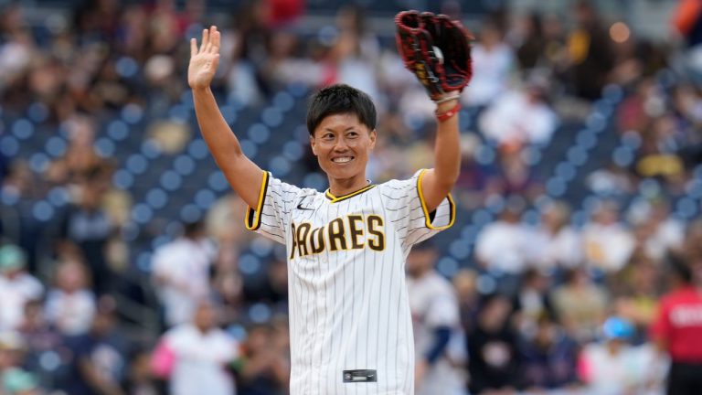 Japanese baseball player Ayami Sato waves to the crowd before throwing out a ceremonial first pitch before the San Diego Padres host the Houston Astros in a baseball game Monday, Sept. 16, 2024, in San Diego. (Gregory Bull/AP)