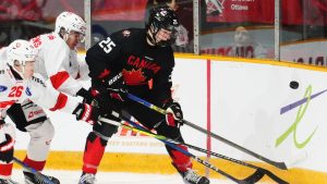 Canada's Matthew Schaefer battles for the puck with Switzerland's Basile Sansonnens during third period IIHF World Junior Hockey Championship pre-tournament action in Ottawa on Thursday, December 19, 2024. (Sean Kilpatrick/CP)