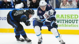 Winnipeg Jets forward Mark Scheifele (55) drives past Toronto Maple Leafs forward David Kampf (64) during third period NHL hockey action in Toronto on Monday, December 23, 2024. (Nathan Denette/CP)